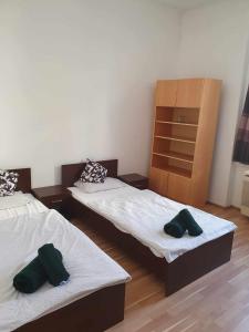 a room with two beds and a dresser at ALWAYS A HUGE SALE! in Budapest