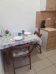 a kitchen with a table and chairs with plates on it at ALWAYS A HUGE SALE! in Budapest