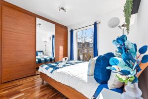 a bedroom with a large bed with blue accents at Blue Themed Luxury 1 Bedroom Balcony Flat, With Double Sofa Bed and Fast Wifi! Accommodates up to 6 Guests! Hyde Park! in London