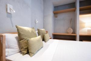 1 dormitorio con 1 cama con sábanas y almohadas blancas en Trinità UrbanHaven - Cuore di Cagliari, en Cagliari