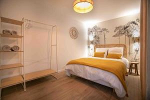 a bedroom with a bed and a clock on the wall at Studio cosy, neuf, hyper centre in Brantôme