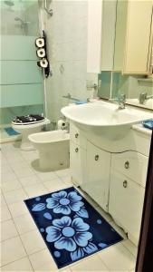 a bathroom with a sink and a toilet and a bathroom rug at La Dimora delle Divinità in Naples