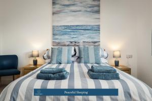 Un dormitorio con una cama con almohadas azules. en Visit Cockleshell, en Carmarthen