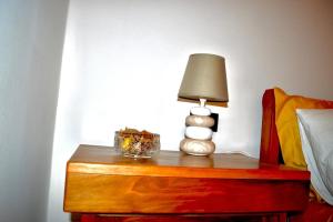 a lamp on a table next to a bed at La Casetta sotto la Torre in Lubriano