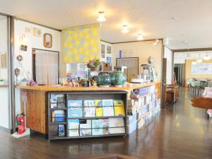 a store with a counter in a room at Pension Arumeria in Wakkanai