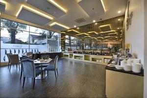 a dining room with a table and chairs in a restaurant at Serela Cihampelas by KAGUM Hotels in Bandung
