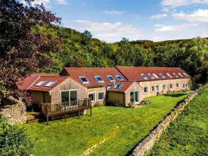 a row of buildings with solar panels on them at Ash Cottage- Uk45892 in Farlam