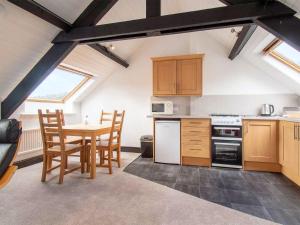 a kitchen with a table and chairs in a room at Bramble Cottage- Uk45891 in Farlam