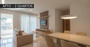 a dining room and living room with a table and chairs at Starlis Home - Versátil in Cuiabá