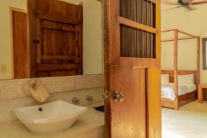 W łazience znajduje się umywalka i lustro. w obiekcie Hotel Hacienda Ticum w mieście Ekmul