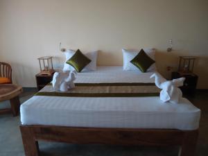 Voodi või voodid majutusasutuse Giman Free Beach Resort toas
