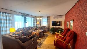 a living room with a couch and a table at ANNA Jeppo Guesthouses in Uusikaarlepyy