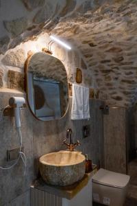 a bathroom with a stone sink and a mirror at Ana Talia House in Mardin