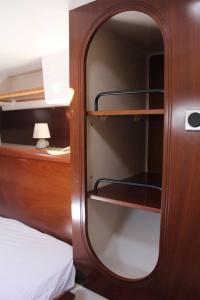 a bedroom with a mirror next to a bed at Cabine d'un catamaran privatisé in Le Marin