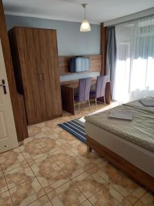 Ένα ή περισσότερα κρεβάτια σε δωμάτιο στο Mini Apartamenty Centrum