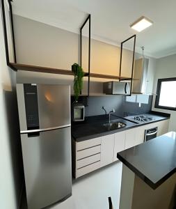 a kitchen with a stainless steel refrigerator and a sink at MY STUDIO in Franca