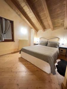 a bedroom with a large bed and a wooden floor at Miramountains in La Thuile