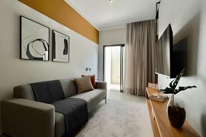 a living room with a couch and a table at My Studio in Franca