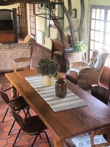 a wooden table with a vase on top of it at Gîte du petit pressoir près du Treport Baie de Somme classé 3 étoiles in Saint-Pierre-en-Val