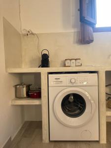 a washing machine in a kitchen with a counter at Nektarios apartment in Mikri Vigla