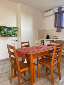 a dining room with a table and chairs and a kitchen at Nektarios apartment in Mikri Vigla