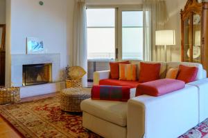 a living room with a couch and a fireplace at Taorminapartments in Taormina +49 photos