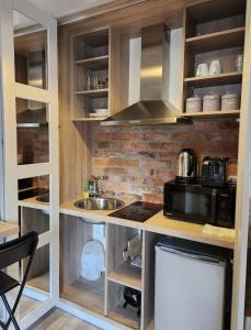 a kitchen with a sink and a microwave at Maynooth Serviced Studios in Maynooth