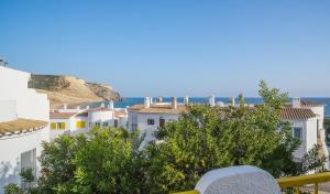 a view from a balcony of white buildings and the ocean at Casa da Praia in Luz