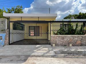 a gate in front of a house at LELÁA A NAJ in Mérida