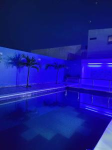 a swimming pool with blue lighting in a building at CASA FINCA TURBACO VIA CAÑAVERAL in Turbaco