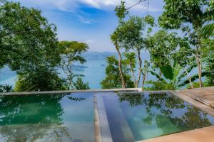 a swimming pool with a view of the water at Tres Piedras in San Francisco Chinameca