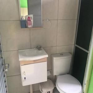 a small bathroom with a toilet and a sink at Apartamento Natureza Verde Manauara in Manaus