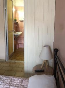 a bedroom with a bed and a lamp and a sink at Marina rooms in Argostoli +49 photos