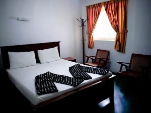 En eller flere senge i et værelse på Surrey Bird Sanctuary & Holiday Resort