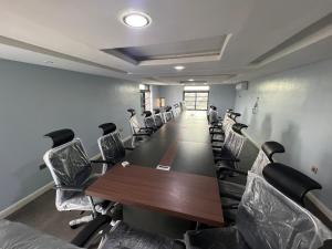 a conference room with a long table and chairs at Ikeja Airport View in Lagos