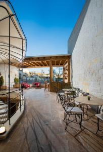 a patio with tables and chairs and a stone wall at Ayazma Cave Hotel in Urgup