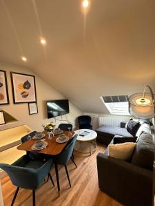 a living room with a table and a couch at Central Cambridge Apartments by Tas in Cambridge