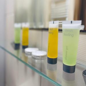 a row of test bottles on a glass shelf at Hotel Galion in Gdańsk