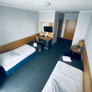 a hotel room with a bed and a desk at Hotel Galion in Gdańsk