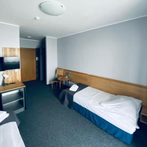 a hotel room with a bed and a desk at Hotel Galion in Gdańsk