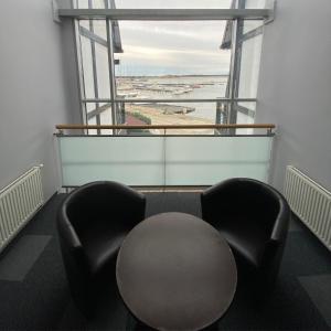 a room with two chairs and a table and a window at Hotel Galion in Gdańsk