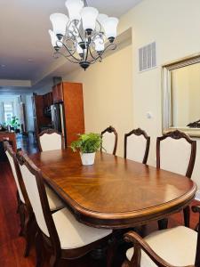 a dining room table with a potted plant on it at Entire Modern Home near Stadiums, Hospitals, and Schools in Baltimore