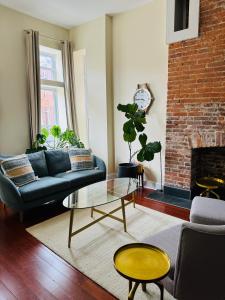 a living room with a couch and a fireplace at Entire Modern Home near Stadiums, Hospitals, and Schools in Baltimore