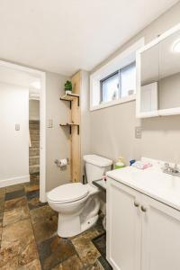 a bathroom with a white toilet and a sink at Whitewater Apartment in Boise +16 photos