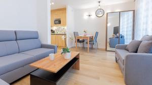 uma sala de estar com um sofá e uma mesa em VacationClub - Apartamenty Zakopiańskie, Apartament 328 em Zakopane