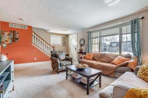 a living room with a couch and a table at Charming Kalamazoo Home with Yard 1 Mi to Downtown! in Kalamazoo