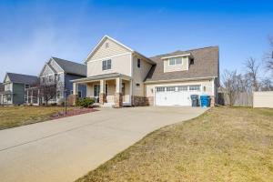 a large white house with a driveway at Charming Kalamazoo Home with Yard 1 Mi to Downtown! in Kalamazoo