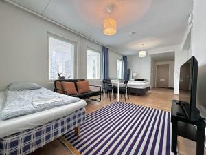 a bedroom with a bed and a living room at Easy Stay Room near Airport in Vantaa
