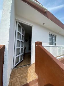 an open door to a balcony of a house at Casa ka'an in Isla Mujeres