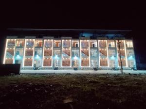 a building with christmas lights on it at night at Devaki Resort in Pondicherry